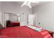 Comfortable bedroom features a mirror sliding closet, neutral paint, and ceiling fan at 17562 W Desert Sage Dr, Goodyear, AZ 85338