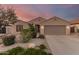 Charming home featuring desert landscaping, neutral stucco, and a two-car garage, perfect for low-maintenance living at 17562 W Desert Sage Dr, Goodyear, AZ 85338