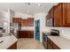Bright kitchen with stainless steel appliances, and a blue pantry door at 17562 W Desert Sage Dr, Goodyear, AZ 85338