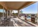 Relaxing covered patio features outdoor kitchen area, barbecue, and view of the pool, perfect for entertaining at 17562 W Desert Sage Dr, Goodyear, AZ 85338