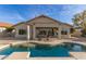 Beautiful backyard showcasing a pristine pool, covered patio, and drought-tolerant landscaping at 17562 W Desert Sage Dr, Goodyear, AZ 85338