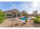 Backyard pool with concrete surround, gravel ground cover, lounge chairs and landscaping at 17562 W Desert Sage Dr, Goodyear, AZ 85338