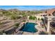 The refreshing pool features custom stonework with desert landscaping and mountain views at 17562 W Desert Sage Dr, Goodyear, AZ 85338