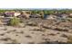 View of an empty lot surrounded by desert landscape with homes in the distance at 17562 W Desert Sage Dr, Goodyear, AZ 85338