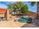 Inviting backyard oasis boasts a lush pond, mature trees and covered patio at 17851 W Calavar Rd, Surprise, AZ 85388