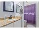 Bathroom featuring granite countertop, bright mirror, and shower with patterned curtain at 17851 W Calavar Rd, Surprise, AZ 85388