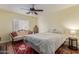 Bedroom with decorative sofa, ceiling fan and queen bed at 17851 W Calavar Rd, Surprise, AZ 85388