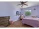 Bedroom with a ceiling fan, bed, and wall-mounted tv at 17851 W Calavar Rd, Surprise, AZ 85388