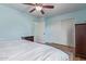 Bedroom with light blue walls, wood floors, and closet at 17851 W Calavar Rd, Surprise, AZ 85388