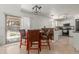 Bright dining area next to kitchen features a modern light fixture and sliding door access to the patio at 17851 W Calavar Rd, Surprise, AZ 85388