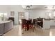 Open dining area with bar seating, tile flooring, and access to the backyard at 17851 W Calavar Rd, Surprise, AZ 85388