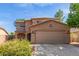 Charming two-story home with a two car garage and a well maintained landscaped front yard at 17851 W Calavar Rd, Surprise, AZ 85388