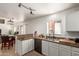 Well-lit kitchen featuring granite countertops, stainless steel appliances, and a view to the breakfast area at 17851 W Calavar Rd, Surprise, AZ 85388