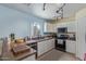 Modern kitchen with granite countertops, white cabinets, and stainless steel appliances at 17851 W Calavar Rd, Surprise, AZ 85388