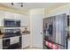 Bright kitchen with stainless steel appliances, granite countertops, and white cabinetry at 17851 W Calavar Rd, Surprise, AZ 85388