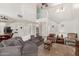Open concept living room with soaring ceilings, lots of light, and a neutral color palette at 17851 W Calavar Rd, Surprise, AZ 85388