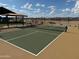 Community amenity featuring a pickleball court with green surface, surrounding fence, and blue sky backdrop at 18090 W Creedance Blvd, Surprise, AZ 85387