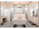 Luxurious bathroom featuring a soaking tub, modern lighting, and stylish vanities at 18125 W Montebello Ct # 67, Litchfield Park, AZ 85340