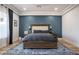 Well-lit bedroom featuring a patterned blue rug and a stylish, upholstered headboard at 18125 W Montebello Ct # 67, Litchfield Park, AZ 85340