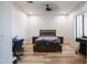 Cozy bedroom with a modern bed, neutral color scheme, and hardwood floors creating a relaxing retreat at 18125 W Montebello Ct # 67, Litchfield Park, AZ 85340