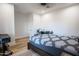 Cozy bedroom features a wooden bed, hardwood floors, and a clean workspace, creating a versatile space at 18125 W Montebello Ct # 67, Litchfield Park, AZ 85340