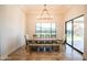 A dining room with hardwood floors, a large window, and an eight person dining table at 18125 W Montebello Ct # 67, Litchfield Park, AZ 85340