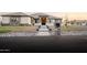 Beautiful single-story home featuring stone accents, lush landscaping, and a well-manicured lawn at 18125 W Montebello Ct # 67, Litchfield Park, AZ 85340