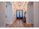 Inviting foyer with herringbone wood floors, designer lighting, and stylish decor at 18125 W Montebello Ct # 67, Litchfield Park, AZ 85340