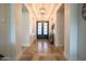 Inviting foyer with herringbone wood floors, designer lighting, and stylish decor at 18125 W Montebello Ct # 67, Litchfield Park, AZ 85340