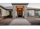 Stunning home entrance featuring a stone archway, elegant chandelier, and stylish double doors at 18125 W Montebello Ct # 67, Litchfield Park, AZ 85340