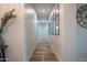 Hallway with recessed lighting, wood floors, and framed art creates a clean, modern transition between rooms at 18125 W Montebello Ct # 67, Litchfield Park, AZ 85340