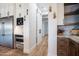 Walk-in pantry with lots of shelving, hardwood floors, and stainless steel appliances at 18125 W Montebello Ct # 67, Litchfield Park, AZ 85340