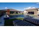 Inviting backyard featuring a pristine pool, lounge chairs, lush turf, and a serene, relaxing atmosphere at 18125 W Montebello Ct # 67, Litchfield Park, AZ 85340