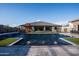 Beautiful backyard featuring a dark blue swimming pool with a water feature and lush landscaping at 18125 W Montebello Ct # 67, Litchfield Park, AZ 85340