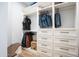 Spacious walk-in closet with custom shelving and ample storage for clothing at 18125 W Montebello Ct # 67, Litchfield Park, AZ 85340