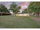 Expansive lawn with mature trees, creating a serene backdrop for outdoor living and recreation at 1886 S 141St Pl, Gilbert, AZ 85295