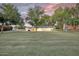 Spacious backyard with lush lawn and mature trees providing a serene and private outdoor space at 1886 S 141St Pl, Gilbert, AZ 85295