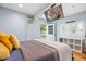 This bedroom has an exterior door and window with a television mounted above the door at 1886 S 141St Pl, Gilbert, AZ 85295