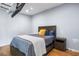 This bedroom is furnished with a wood bed frame, nightstand, and hardwood flooring at 1886 S 141St Pl, Gilbert, AZ 85295