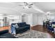 Open living room boasts natural light, modern ceiling fan, and seamless flow to the kitchen and dining areas at 1886 S 141St Pl, Gilbert, AZ 85295