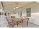 Covered patio with white ceiling, fan, table and chairs for relaxing and outdoor dining at 1886 S 141St Pl, Gilbert, AZ 85295