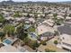 Overhead view of homes with backyard pools surrounded by lush landscaping in a desert community at 19010 N 35Th Way, Phoenix, AZ 85050