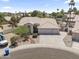 An aerial view of the house, complete with a three-car garage and meticulously maintained landscaping at 19010 N 35Th Way, Phoenix, AZ 85050