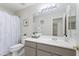 A full bathroom has a large vanity, shower with tub, toilet, and large mirror at 19010 N 35Th Way, Phoenix, AZ 85050