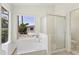 Bathroom featuring a garden tub, shower, and natural light at 19010 N 35Th Way, Phoenix, AZ 85050