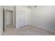 Bedroom features neutral carpet, closet, and an exterior door to a patio at 19010 N 35Th Way, Phoenix, AZ 85050