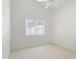 Neutral bedroom featuring carpet and a ceiling fan, and a view of the backyard at 19010 N 35Th Way, Phoenix, AZ 85050