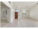 Inviting entryway with a decorative wood door, clerestory window, and neutral tile flooring at 19010 N 35Th Way, Phoenix, AZ 85050