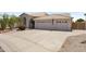 Inviting home showcasing a three-car garage, desert landscaping, and a well-maintained front yard at 19010 N 35Th Way, Phoenix, AZ 85050