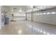 Well-lit garage features epoxy flooring, storage cabinets, and multiple overhead doors at 19010 N 35Th Way, Phoenix, AZ 85050
